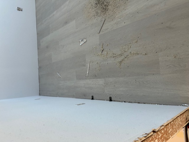 Plank flooring installation in progress with trimmed offcuts in a Las Vegas room