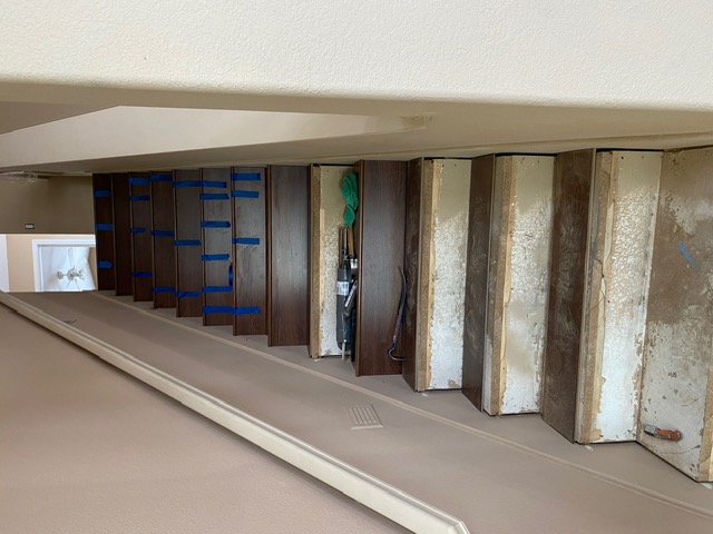 Dark walnut stair treads replacing worn stairs during a Las Vegas remodel