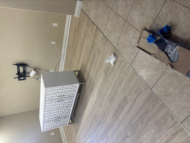 New wood-look flooring replacing an old tile floor during a Las Vegas floor replacement