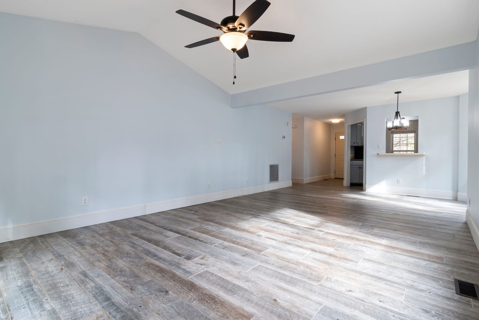 Light wood-look laminate flooring in a bright, renovated Las Vegas room