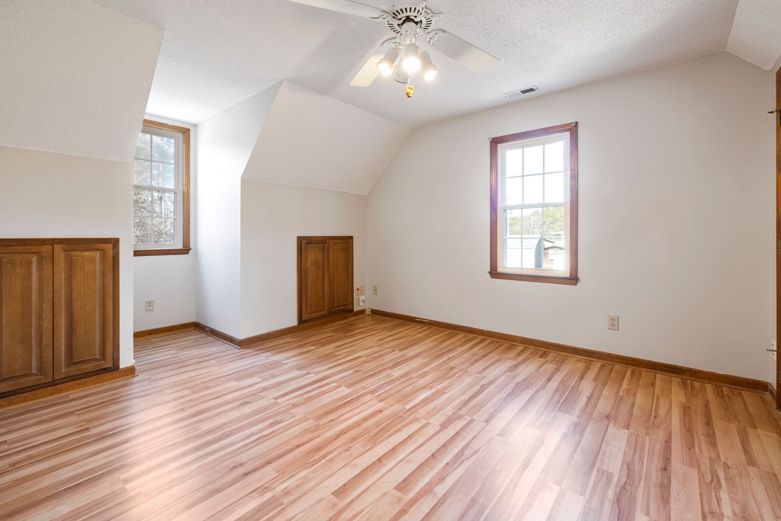 Light laminate wood flooring in a bright Las Vegas bonus room