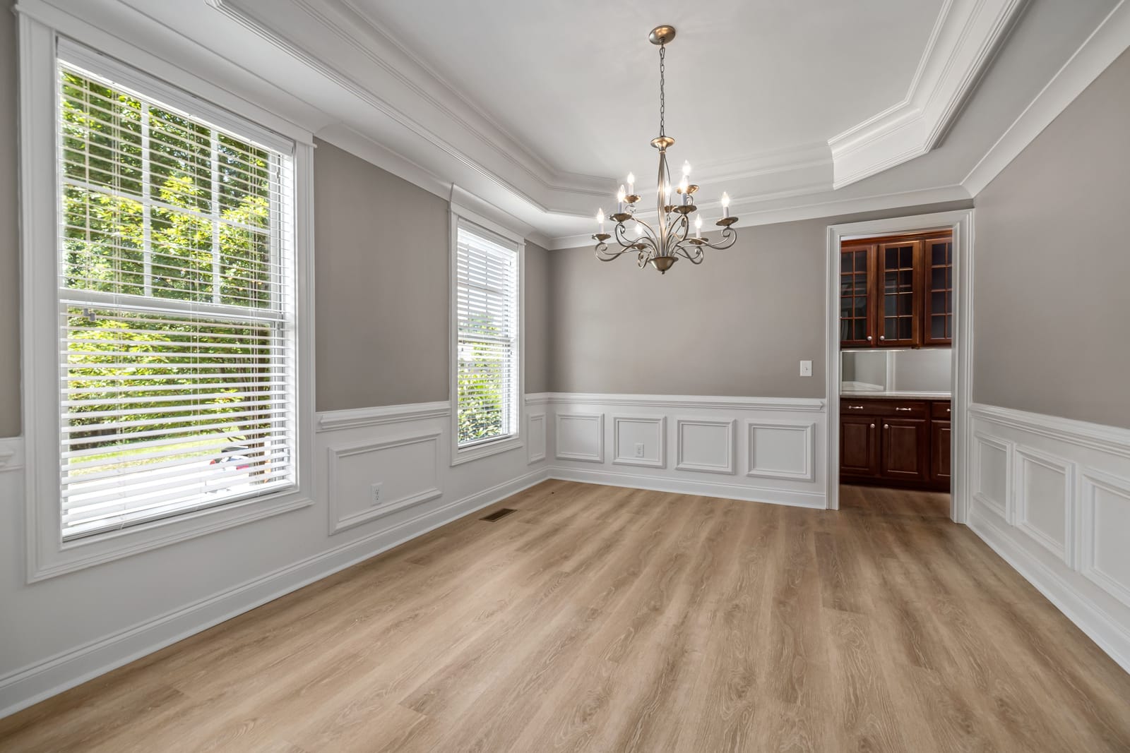 Light luxury vinyl plank flooring in a Las Vegas dining room with wainscoting