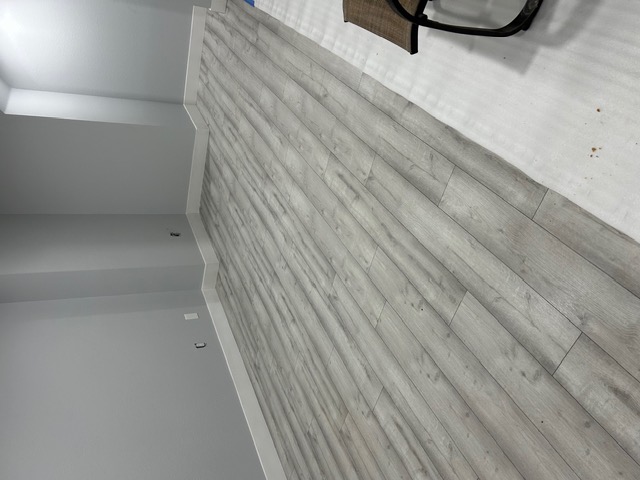 Wide-plank wood-look flooring in a bright, freshly renovated Las Vegas room